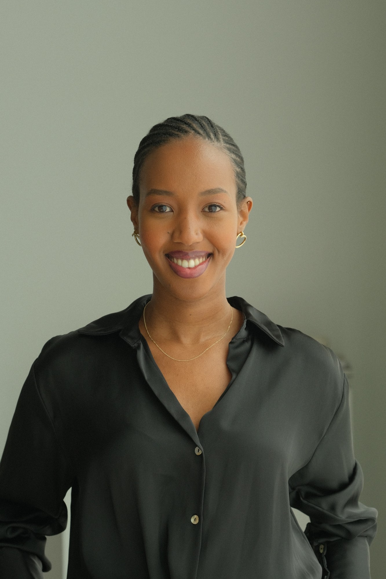 Portrait of Davina Agasaro smiling, in a black silk shirt